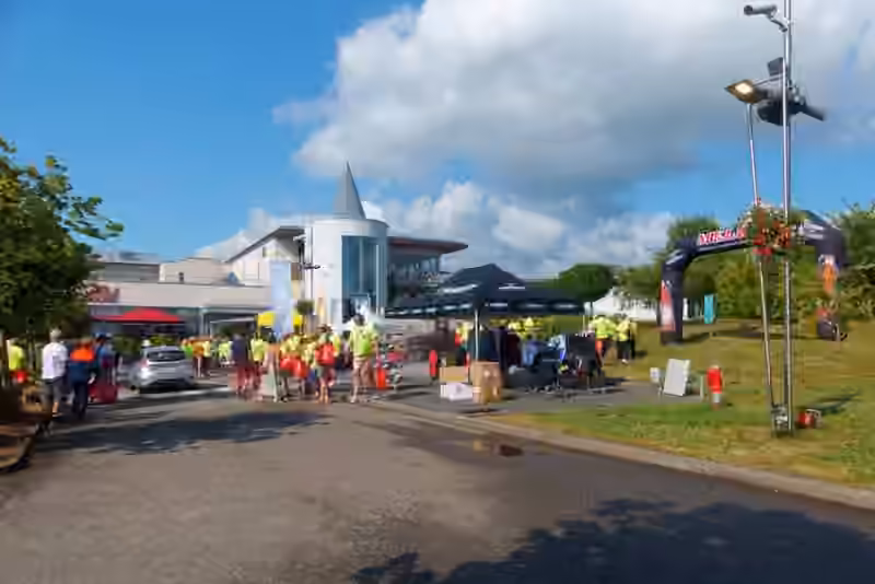 The approach road to the resort in Ribeauvillé in July 2024, with the hotel building and its round tower behind the stands of the Tour Alsace cycling race