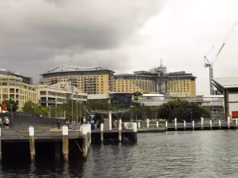 The Star complex in Pyrmont, Sydney, which contains The Star Grand Hotel, seen across the water from a wharf in 2011, with The Star signs on top of its two large sand-coloured blocks