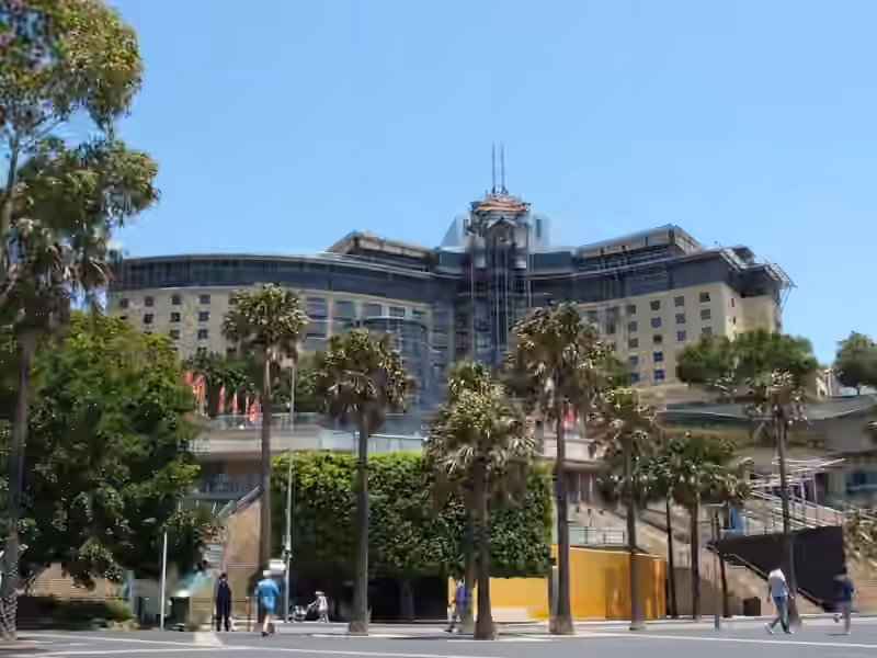 The harbour side of the same complex in 2007, when it was called Star City, with palm trees and wide steps in front of the curved main block