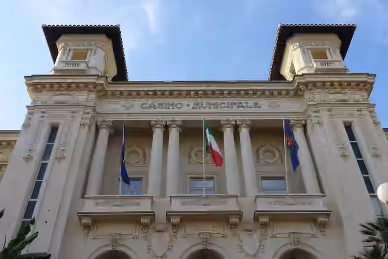 Upper part of the casino facade with columns, flags and the date 1905