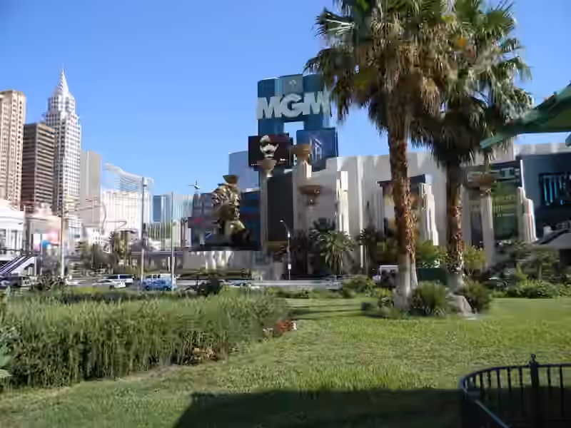 The bronze lion statue at the front entrance of MGM Grand in 2010, seen across a lawn with palm trees
