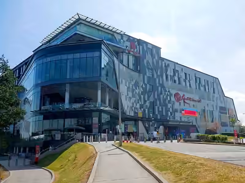 The Resorts World Birmingham building, which houses the casino, with a curved glass corner and a facade of grey and white triangular panels carrying the Resorts World sign